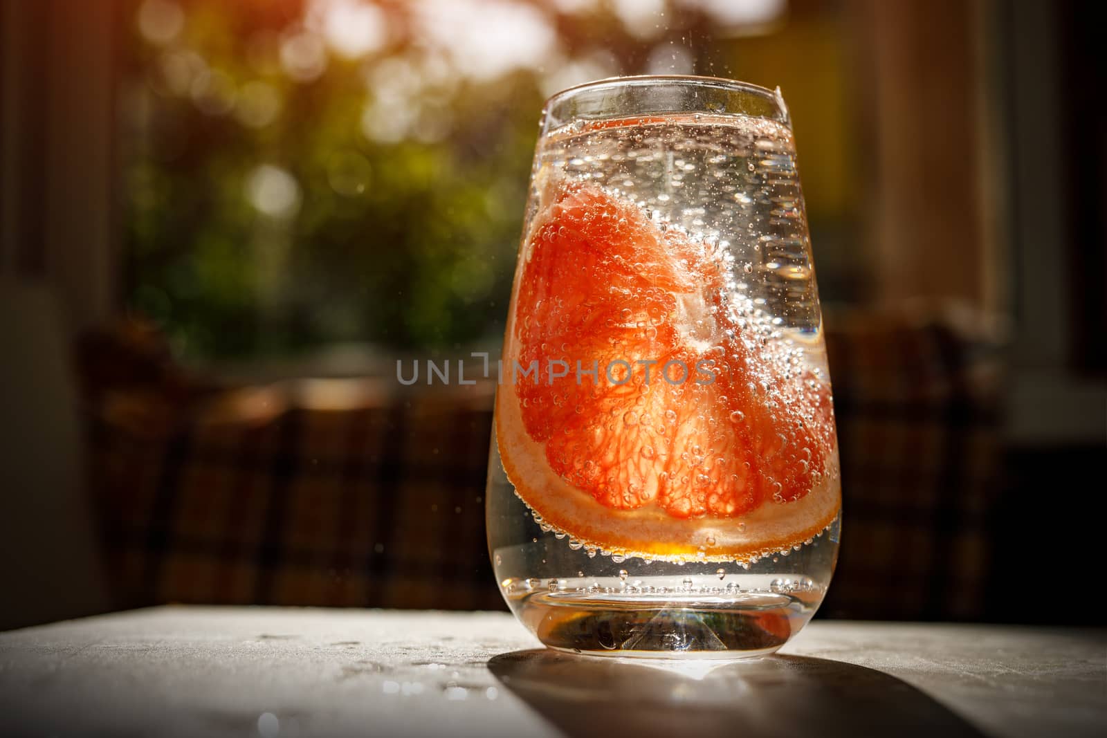 A glass of water with grapefruit