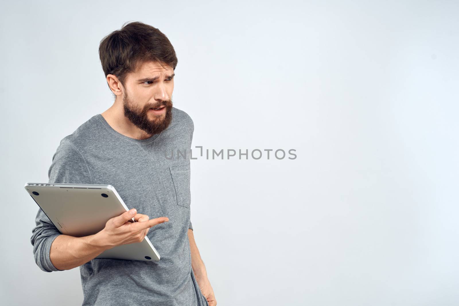 Man with laptop in hands technology internet self-confidence light background. High quality photo