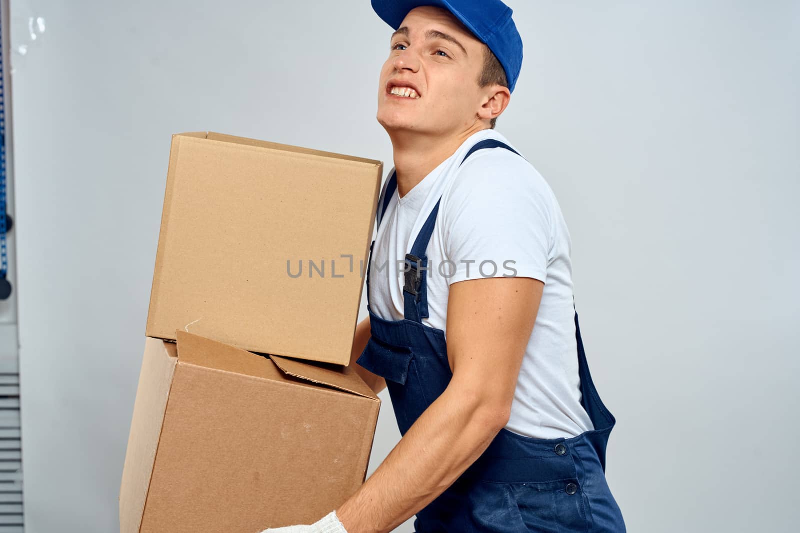 working man in uniform with boxes in his hands delivery loader lifestyle by SHOTPRIME