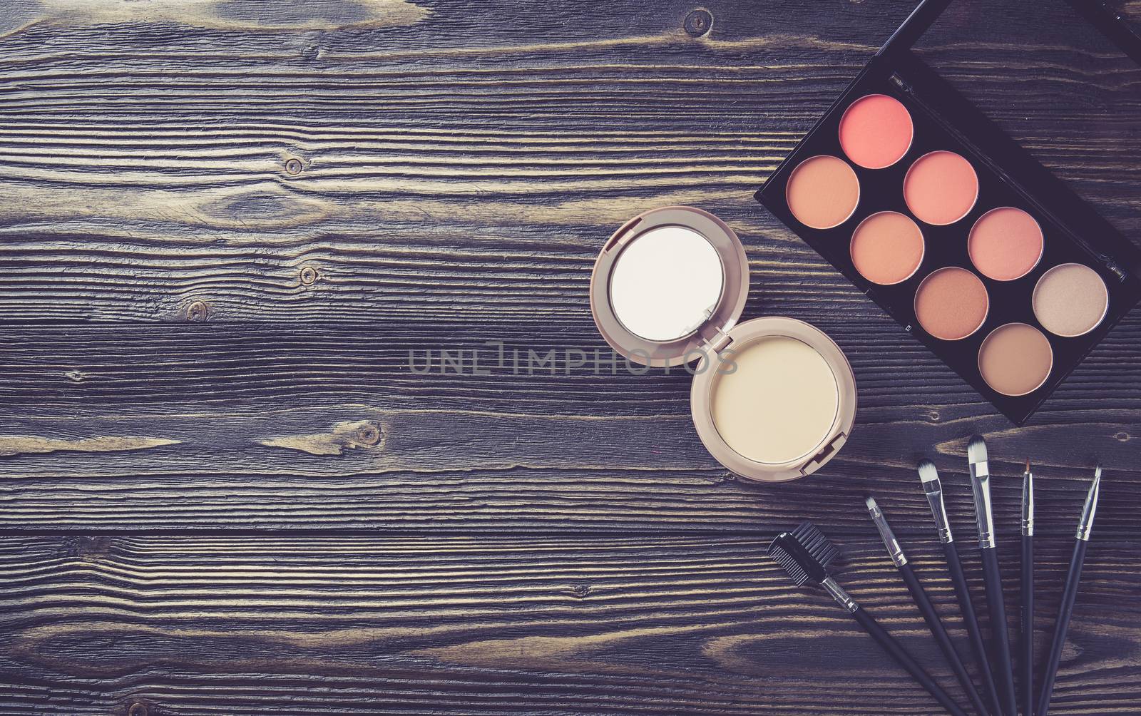Top view a collection of cosmetic makeup on wooden table background, products cosmetic fashion concept, vintage retro style.