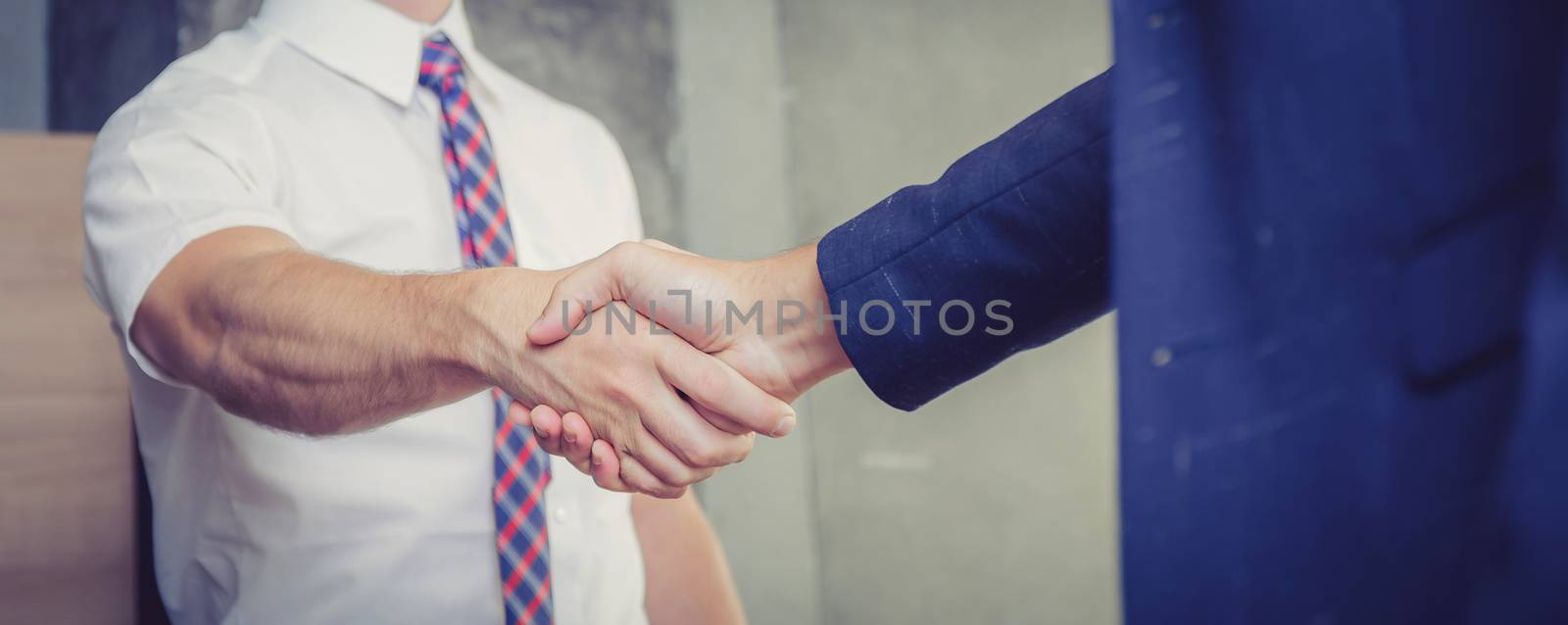Business handshake with partner of success at the meeting room, businessman congratulation with teamwork, leader agreement of team concept, banner background.