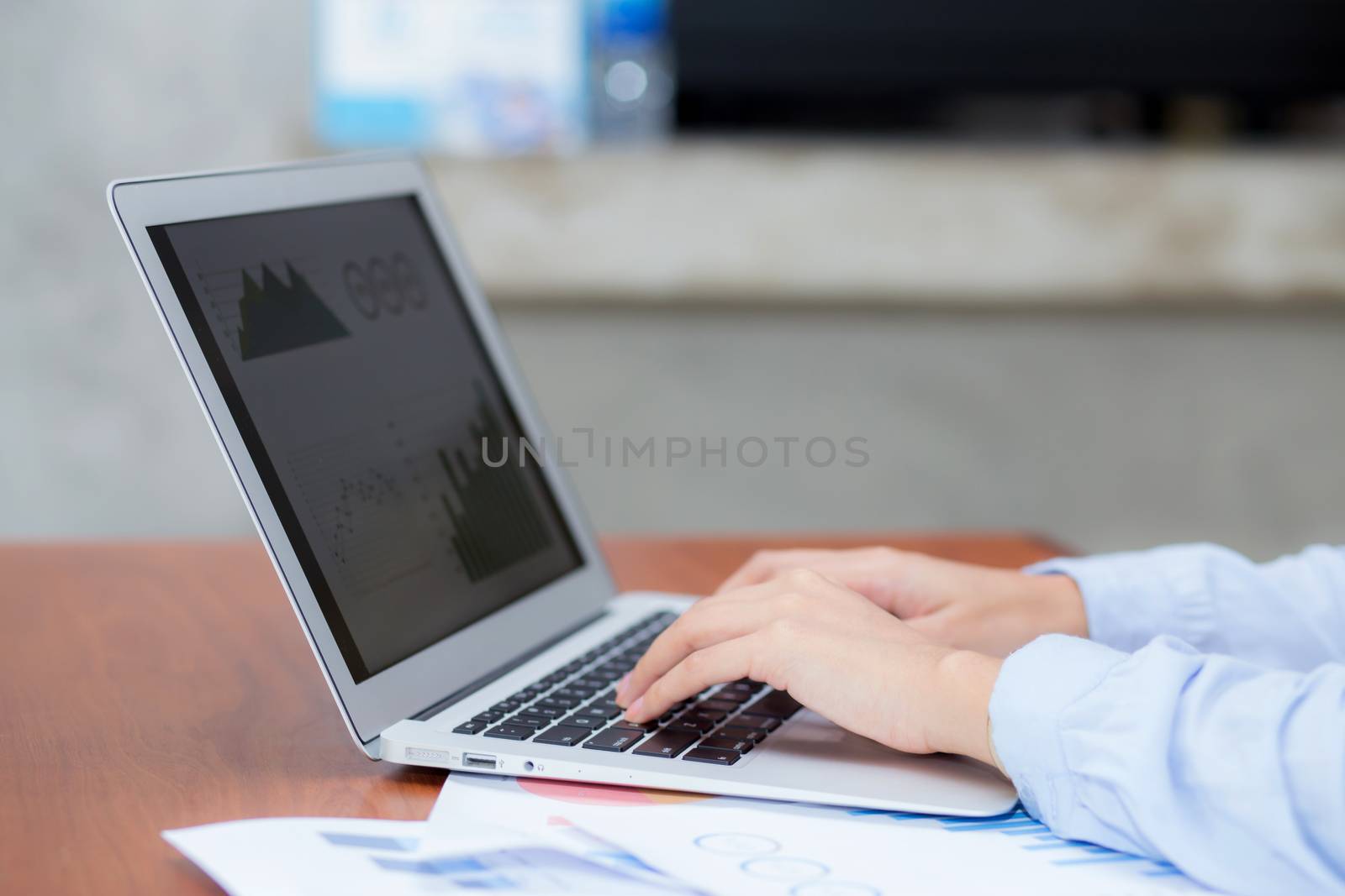 Closeup work with finance analysis and planing data on laptop, typing and paper graph with computer statistic for success, business freelance concept.