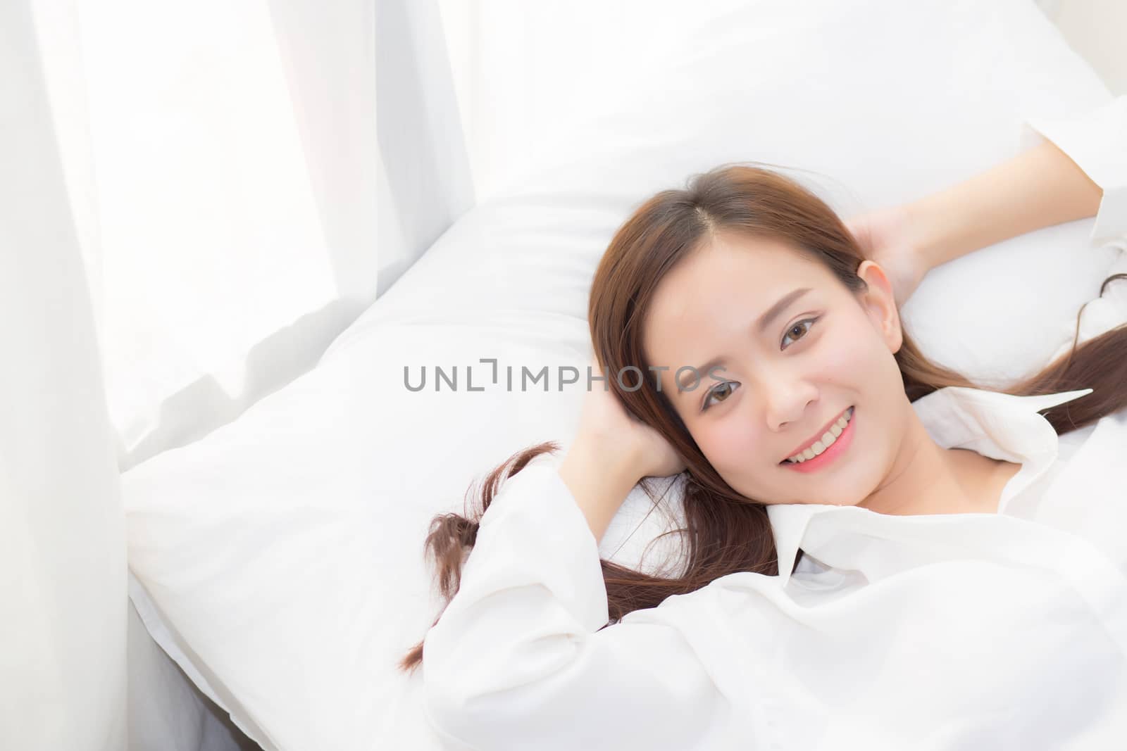 Beautiful asian young woman sleeping lying in bed with head on pillow comfortable and happy. girl with relax for health concept.