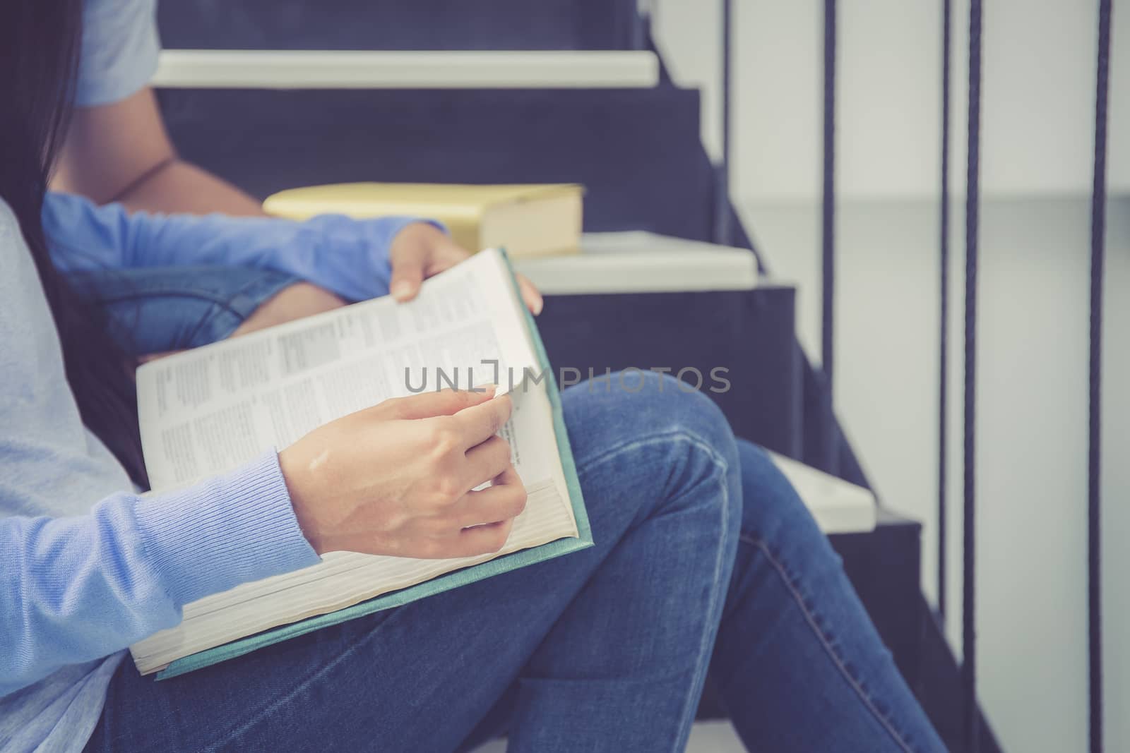 Closeup couple asian handsome man and beautiful woman reading bo by nnudoo