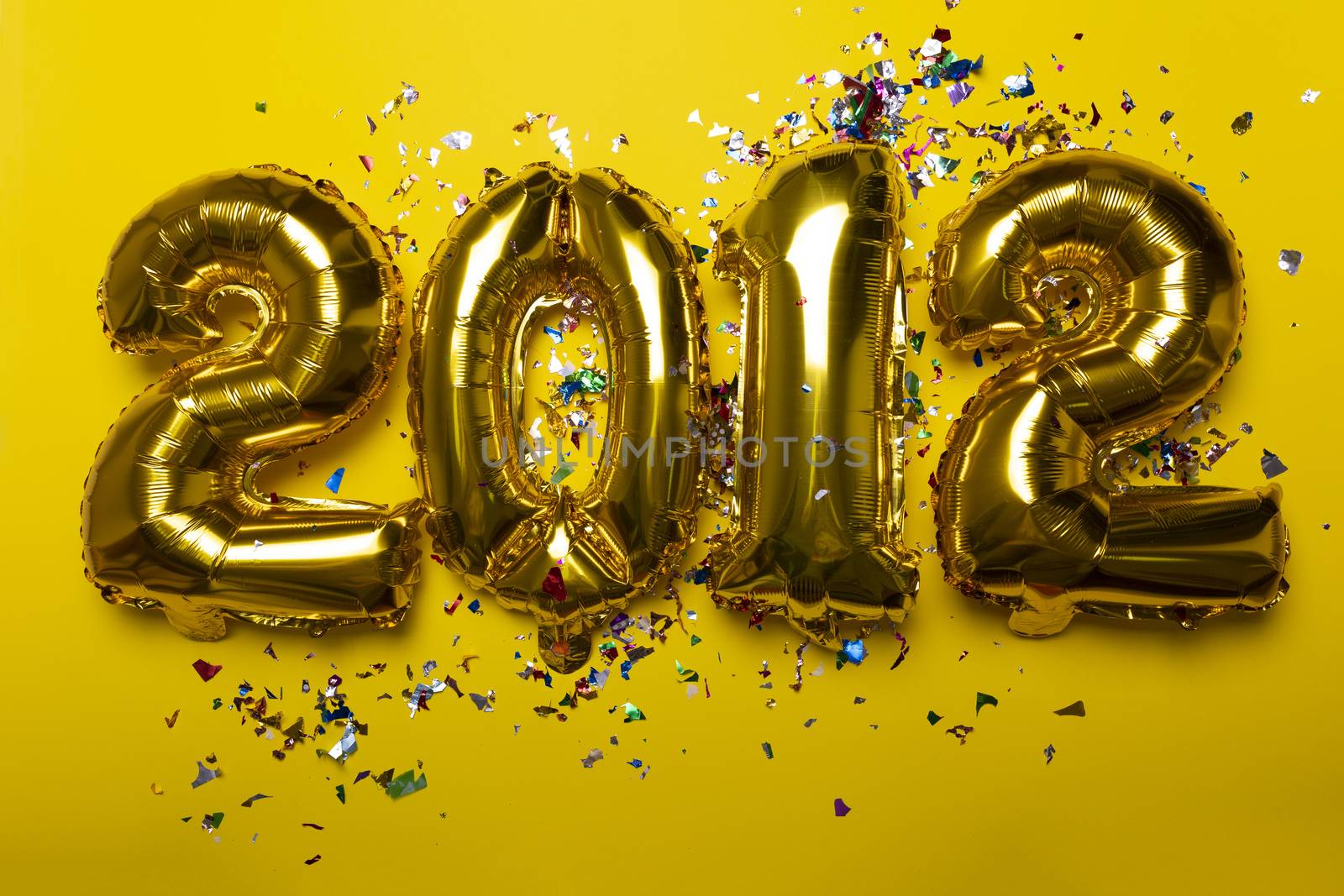 2021 concept new year from golden foil balloon and confetti on yellow background stock photo