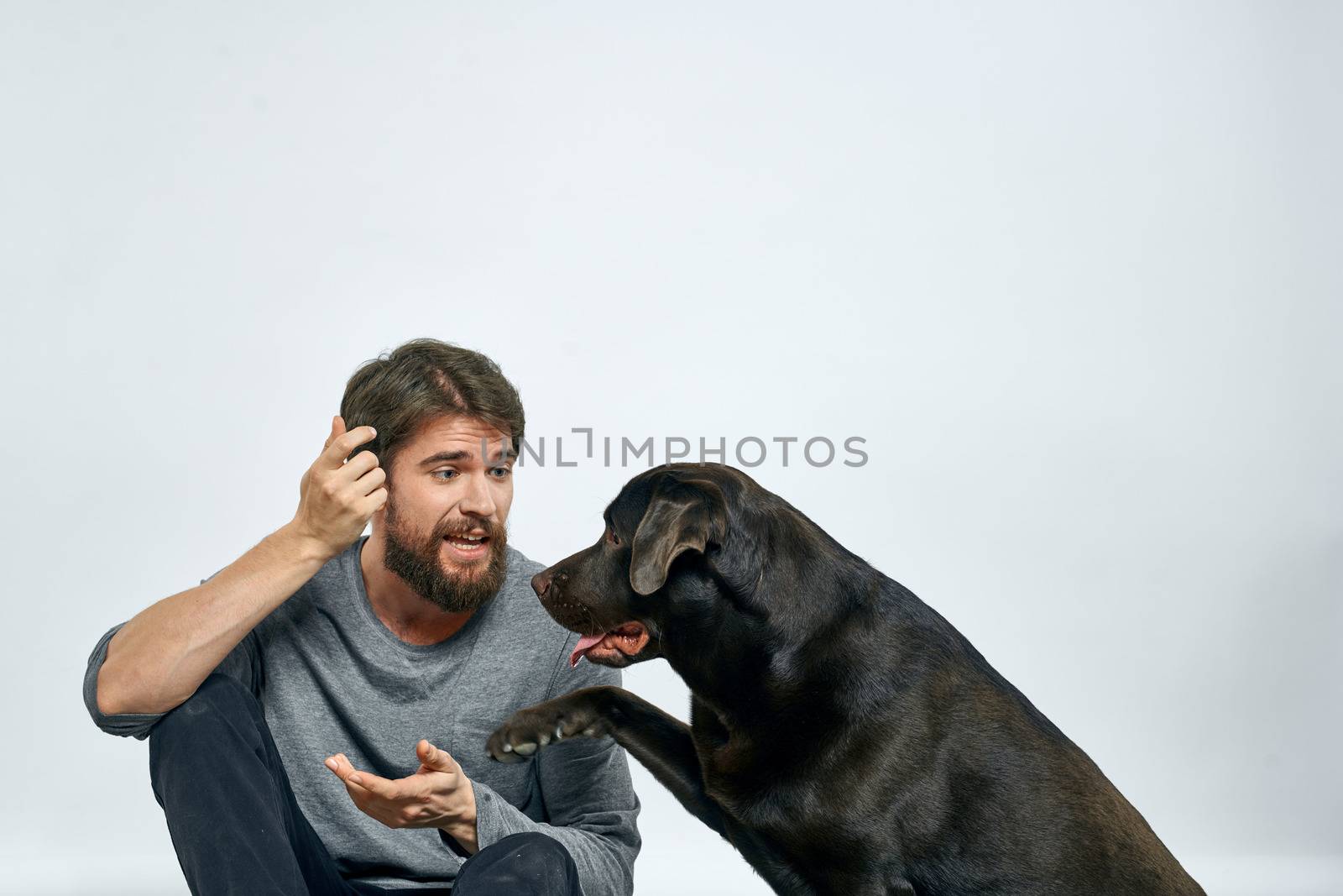 happy owner with pet black dog training model emotions by SHOTPRIME