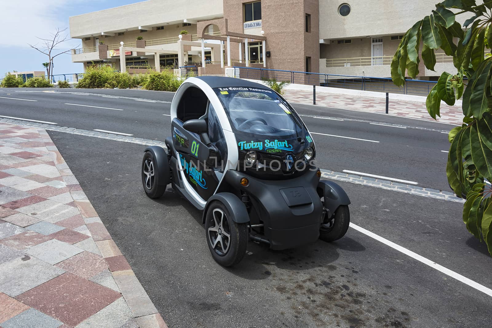 Renault Twizy car is parked in a city street (Tenerife, Spain) by Grommik