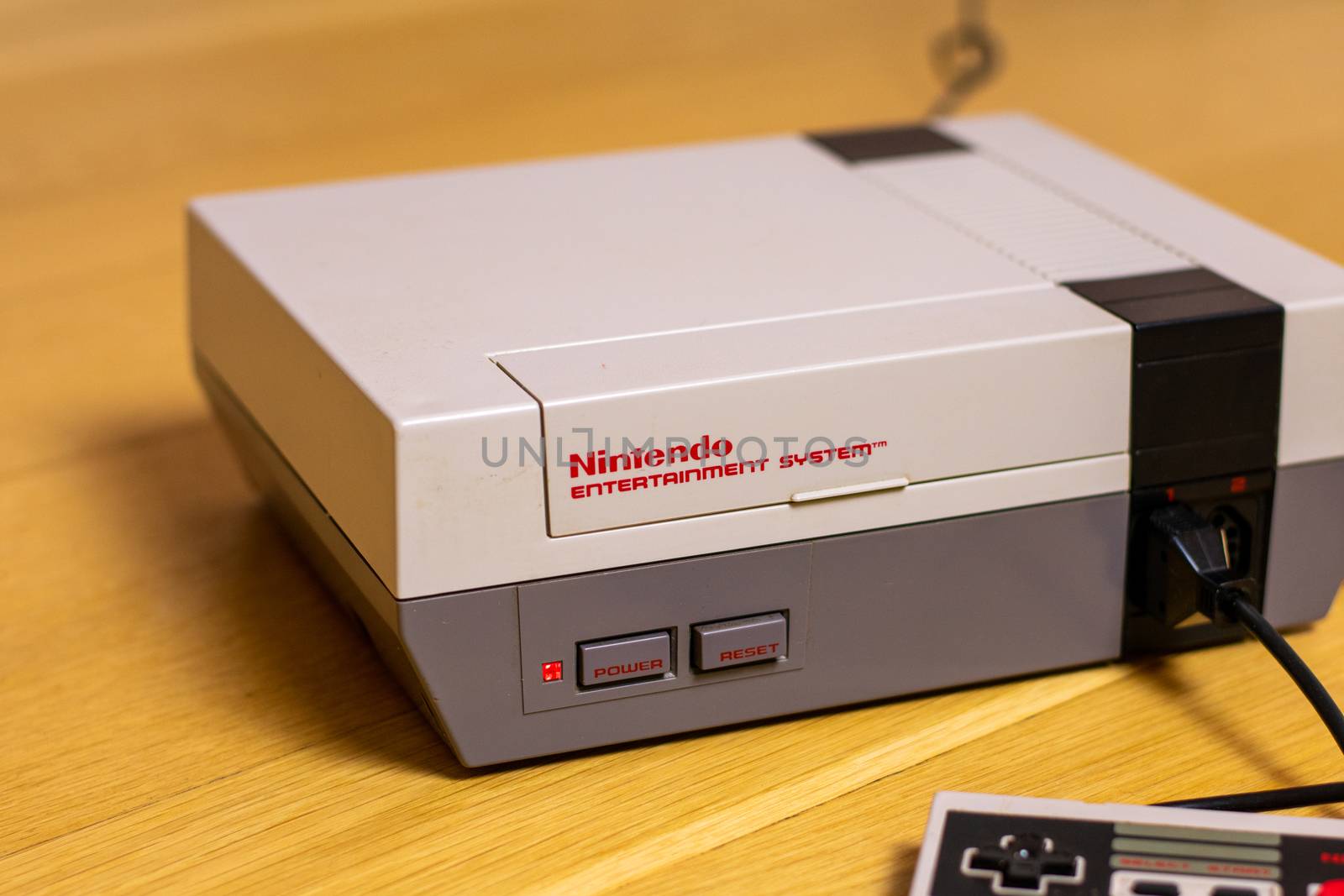 A Nintendo Entertainment System With a Controller Plugged In. The NES is a popular retro console.