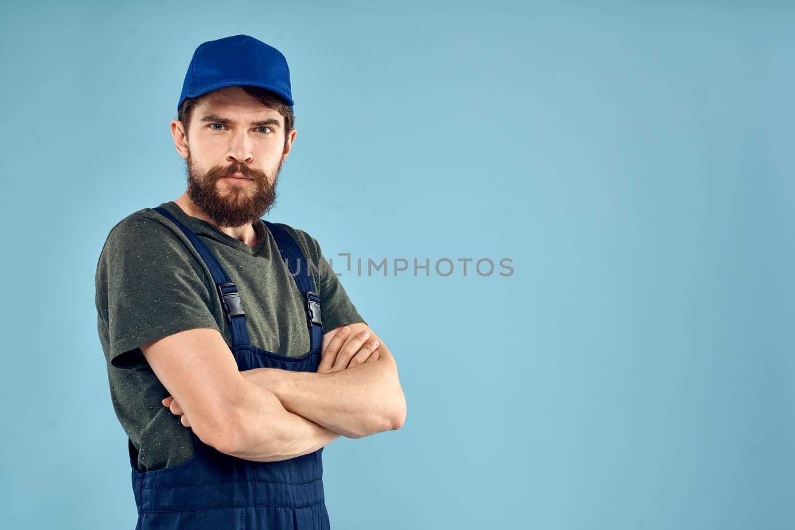 man in work uniform uniform professional work lifestyle delivery service blue background. High quality photo