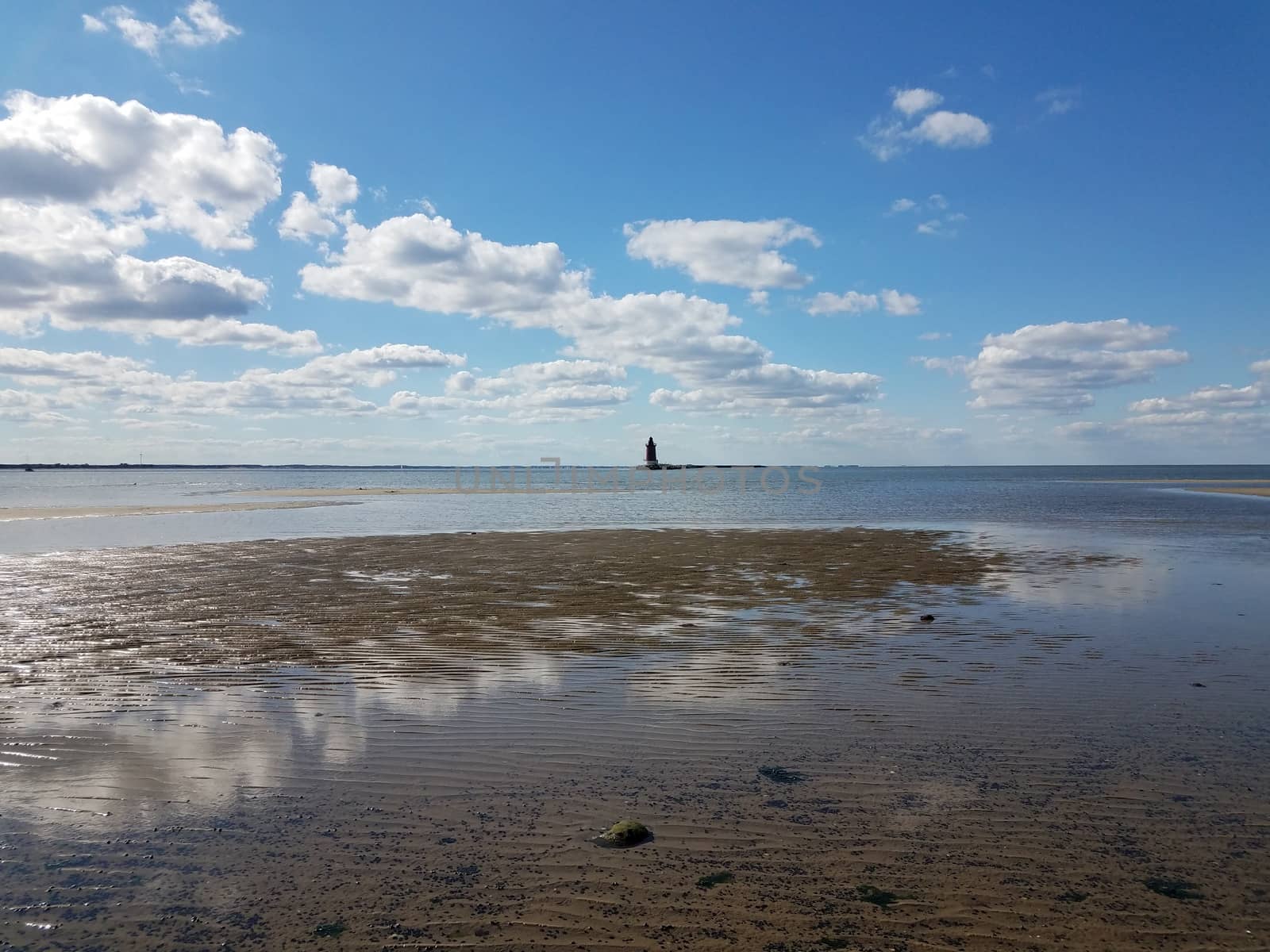 water and sand and lighthouse at ocean or sea