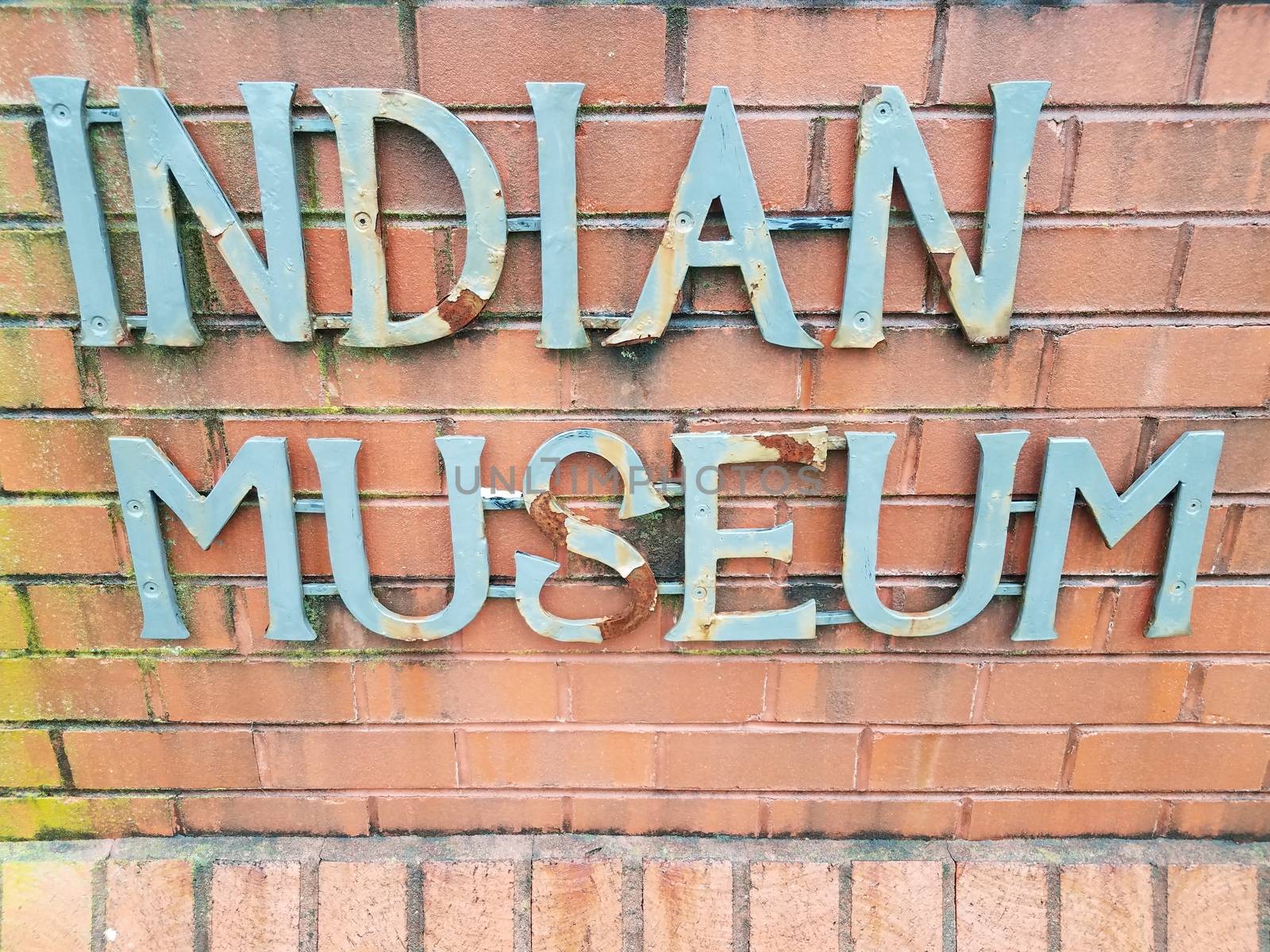 indian museum sign on red brick wall or masonry