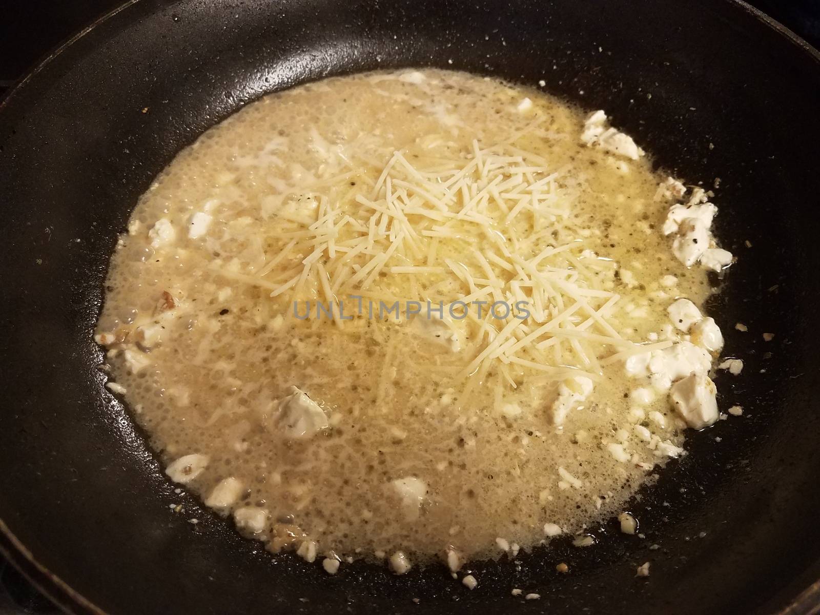 brown sauce with butter and cheese in skillet or frying pan