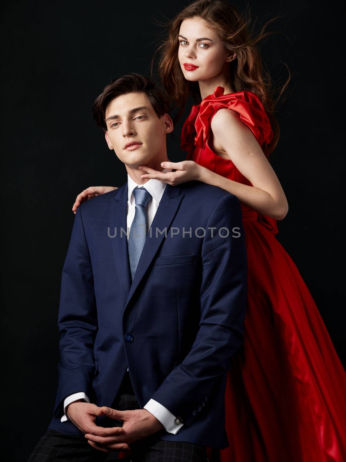 Charming couple man in suit woman in red dress relationship by SHOTPRIME