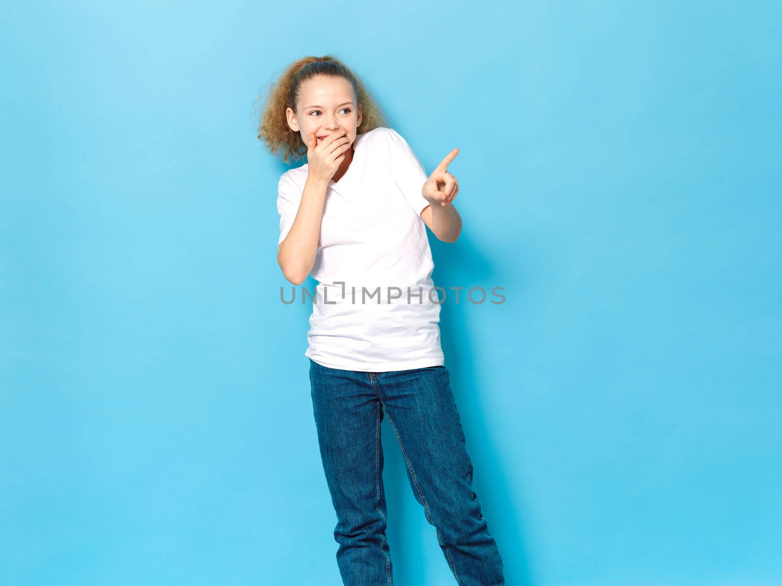 cheerful girl in a white t-shirt gesturing with her hands lifestyle casual clothes blue isolated background copyspace