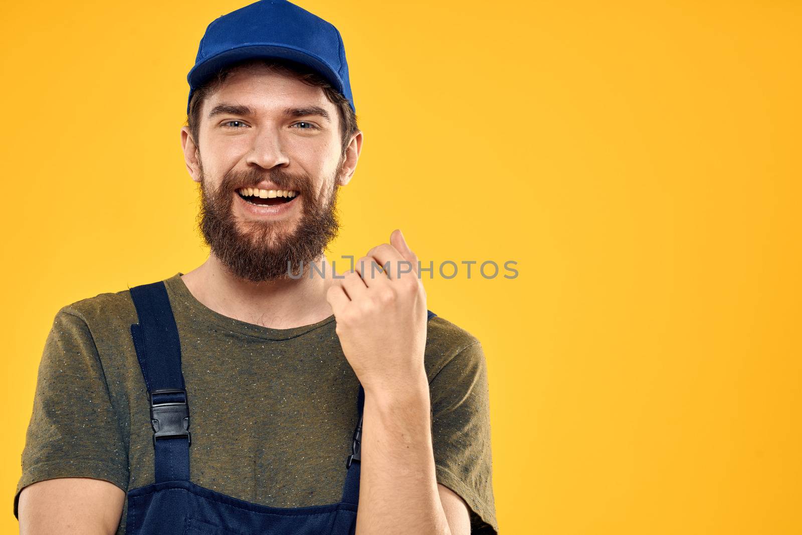 Worker man in uniform worker service yellow background emotion by SHOTPRIME