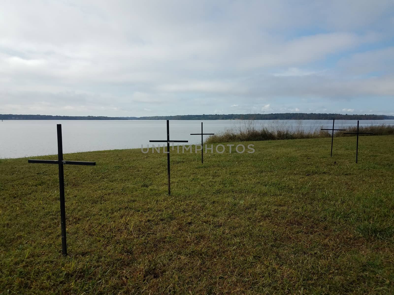 crosses on green grass or lawn near river water