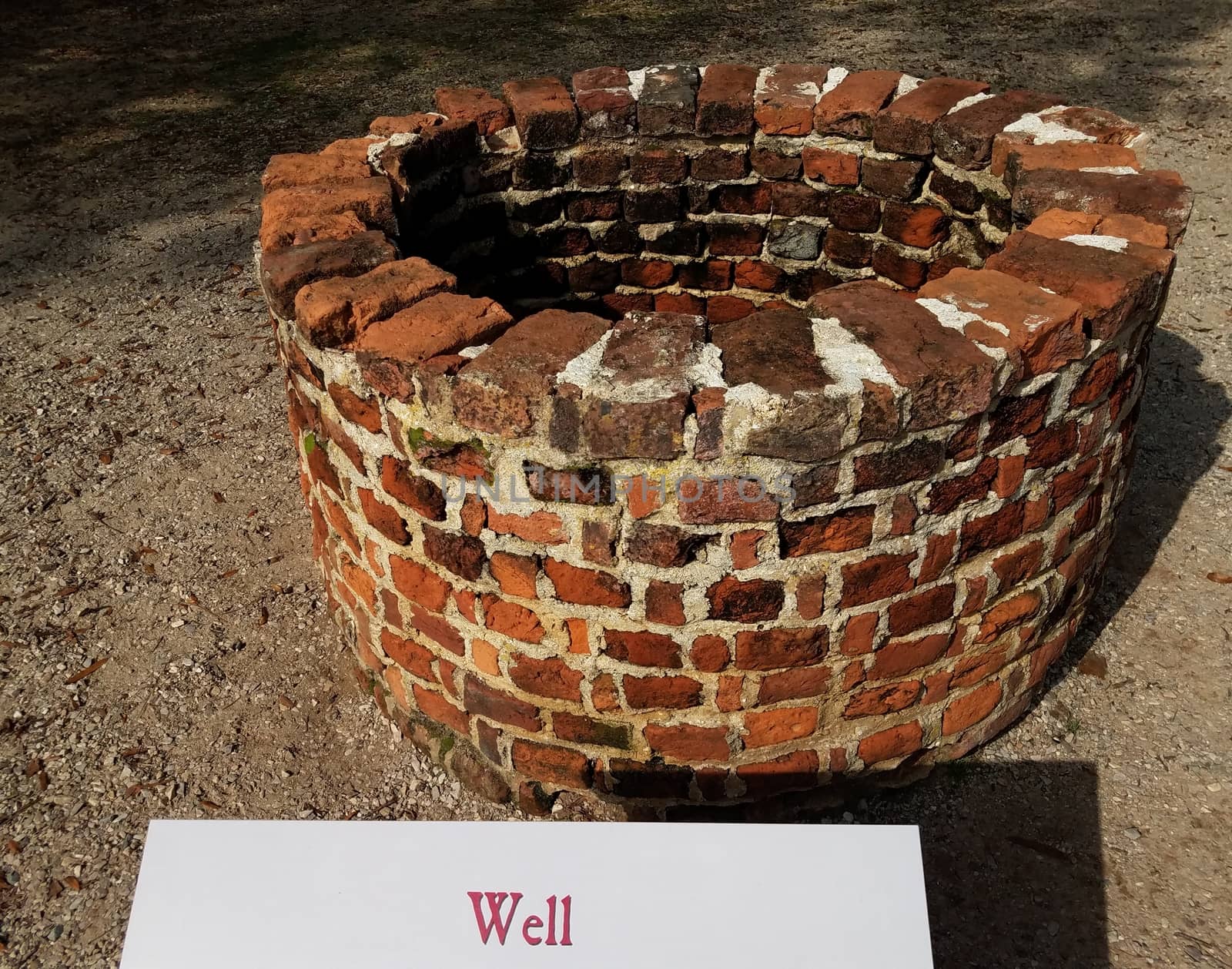 red brick well with sign or label by stockphotofan1