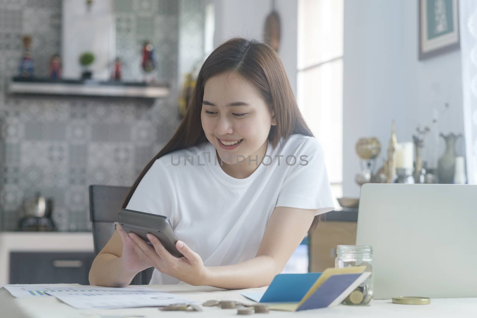 Attractive young Asia woman working at home. Working and learning from home.

