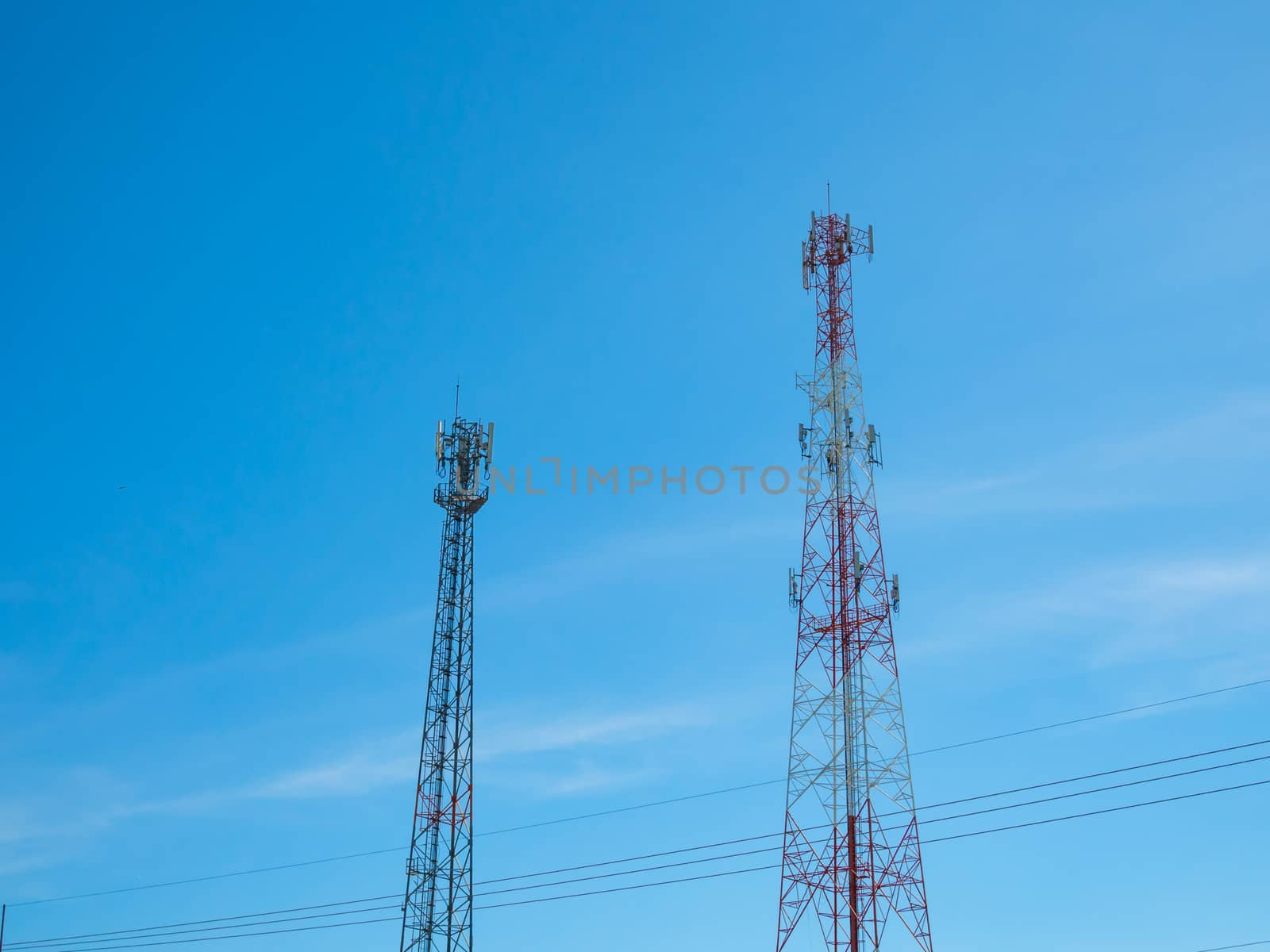 Telephone tower On the background is a bright blue sky.