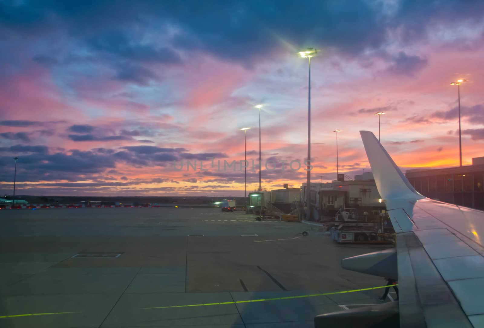 Peaceful twilight evening scene in the airport with a plane wing by eyeofpaul