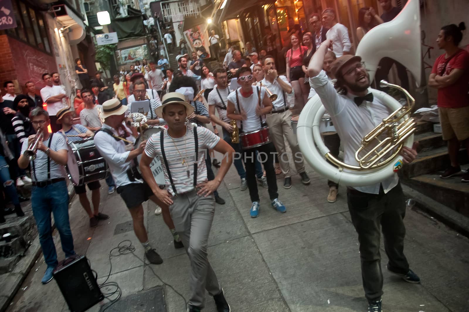 HONG KONG, HONG KONG SAR - NOVEMBER 17, 2018: Local French musician s gathers to play music for mini concert in Lan Kwai Fong Alley in the evening. There are many people in the scene.