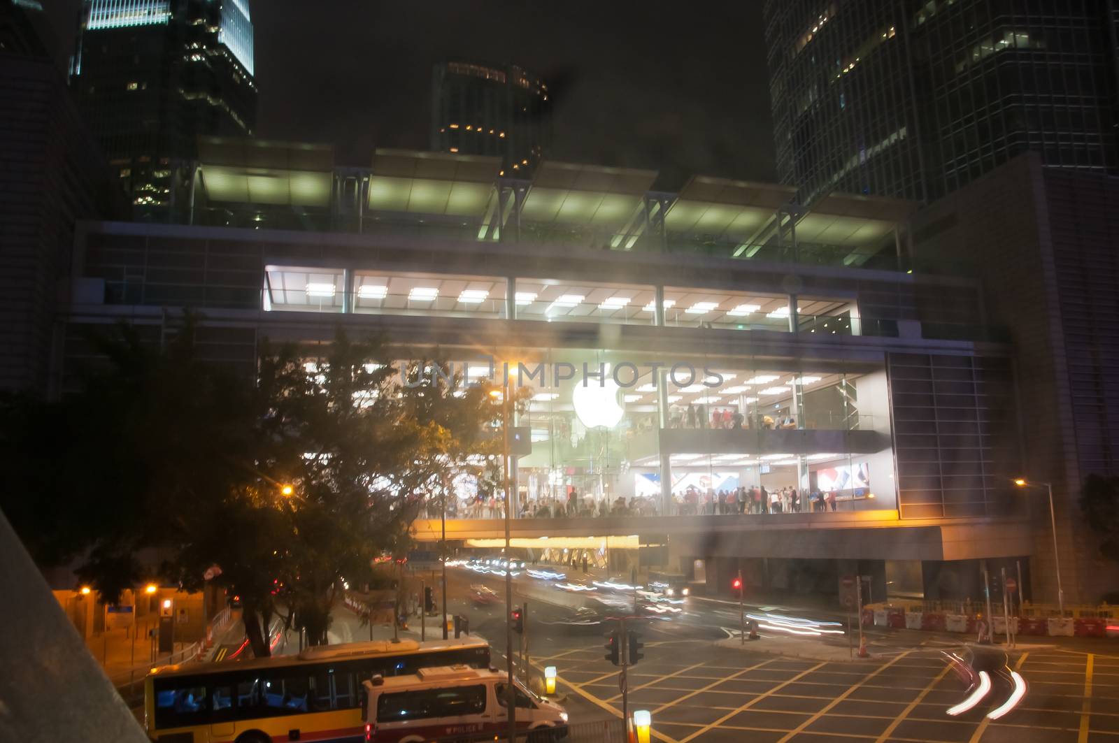 HONG KONG, HONG KONG SAR - NOVEMBER 17, 2018: Bright shiny Apple store in Central Hong Kong at night. There are many people inside the store.