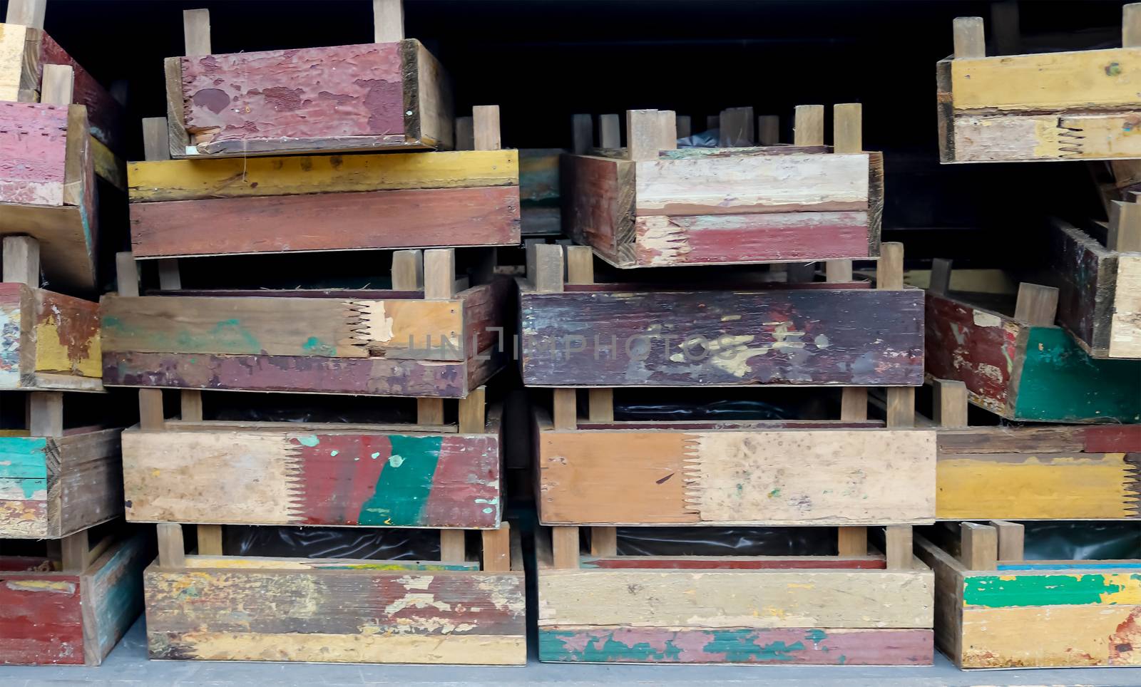 Vintage wooden crates in a shelf for sale in a small shop