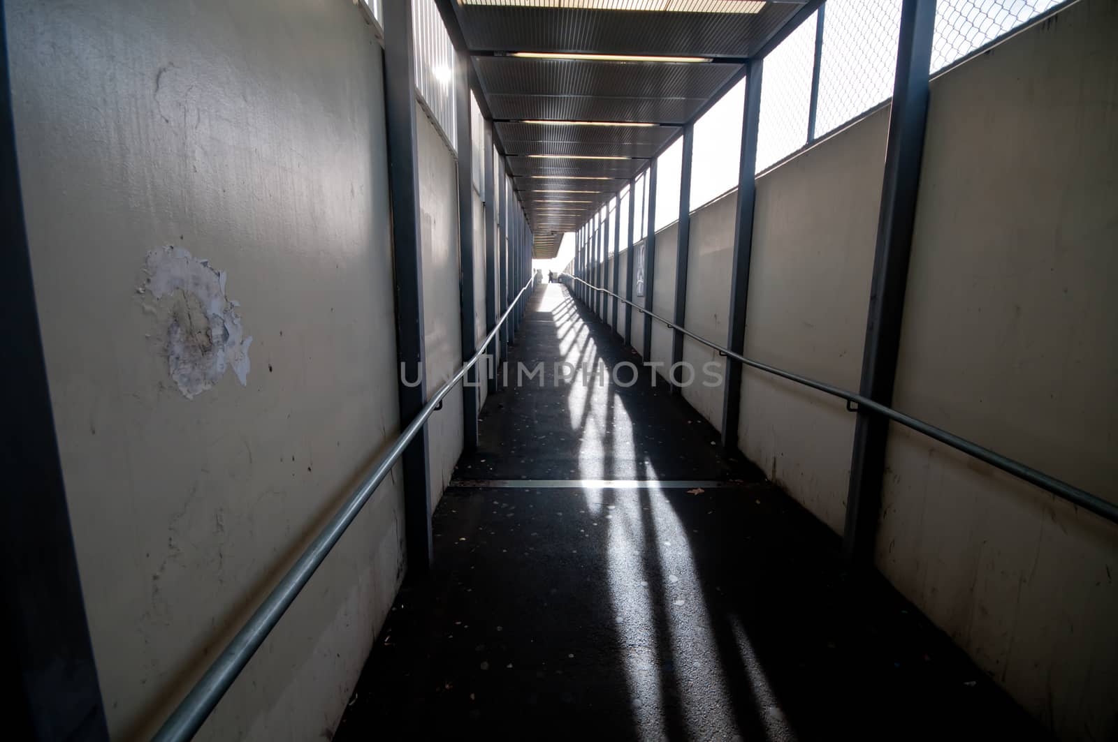 Old empty silent narrow walk way alley with rails by eyeofpaul