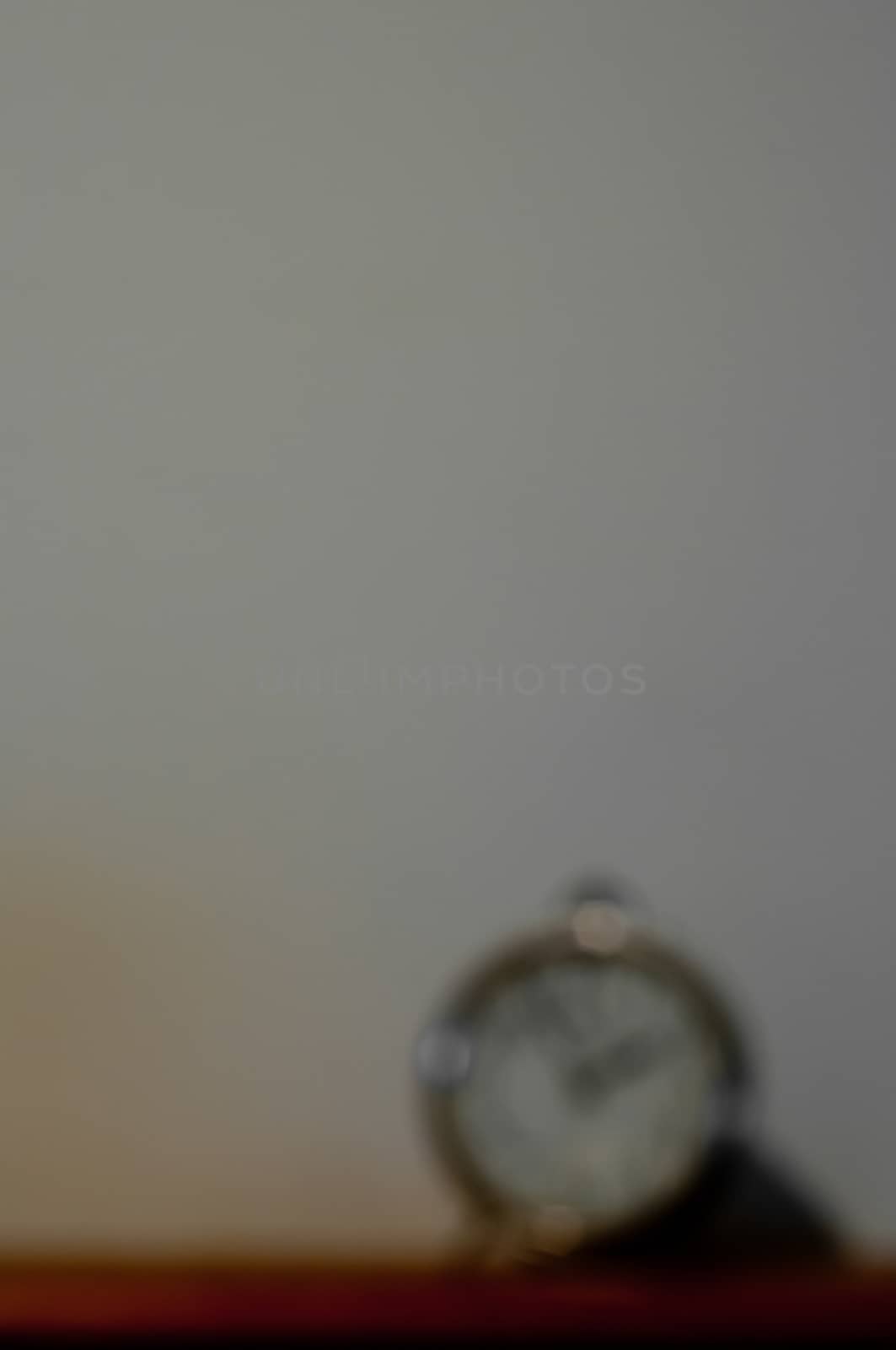 Defocused blurred vintage classic clock on a table with copyspac by eyeofpaul