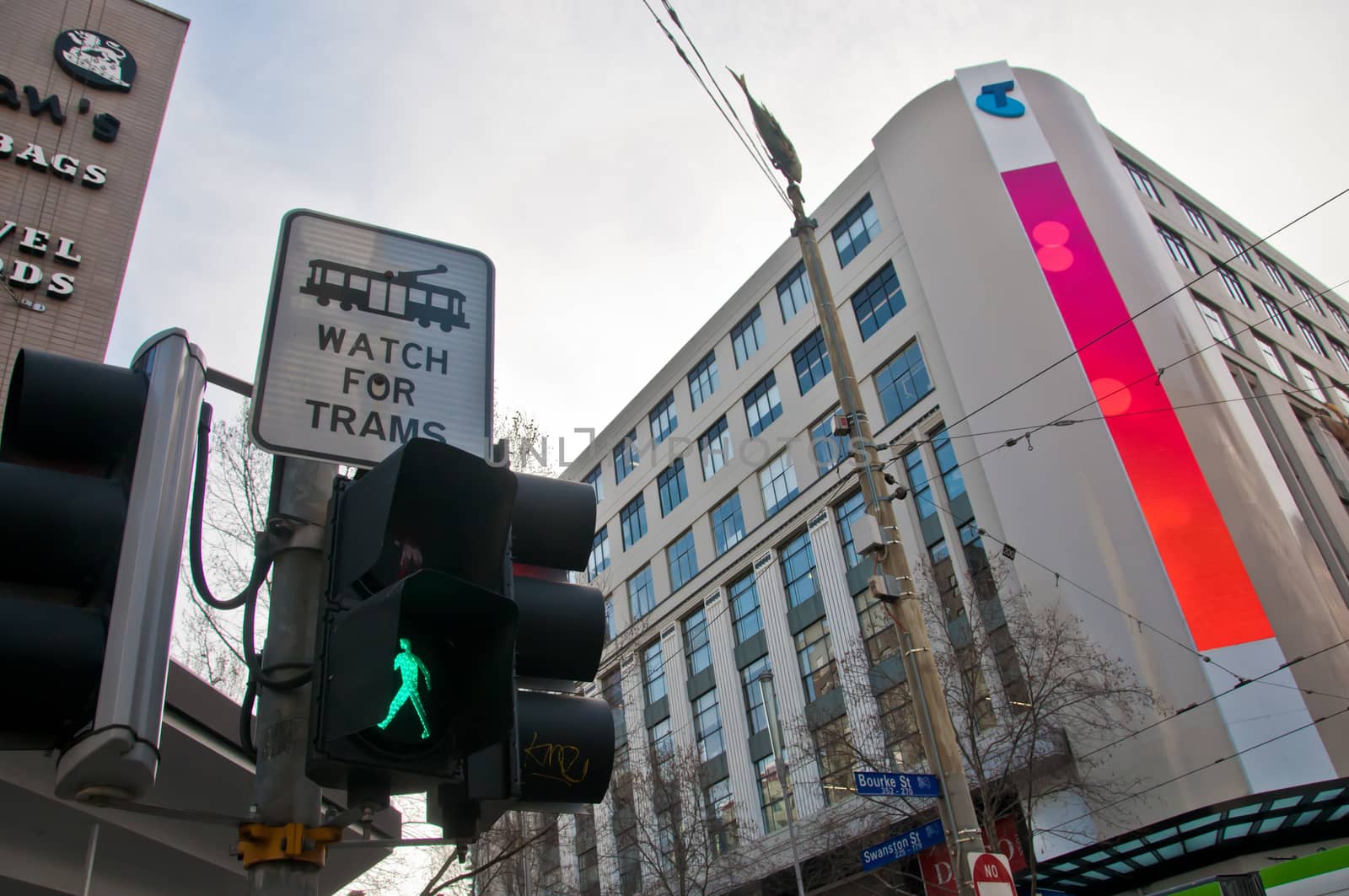 MELBOURNE, AUSTRALIA - JULY 26, 2018: Busy intersection with a warning sign to watch from trams in middle of Melbourne Australia