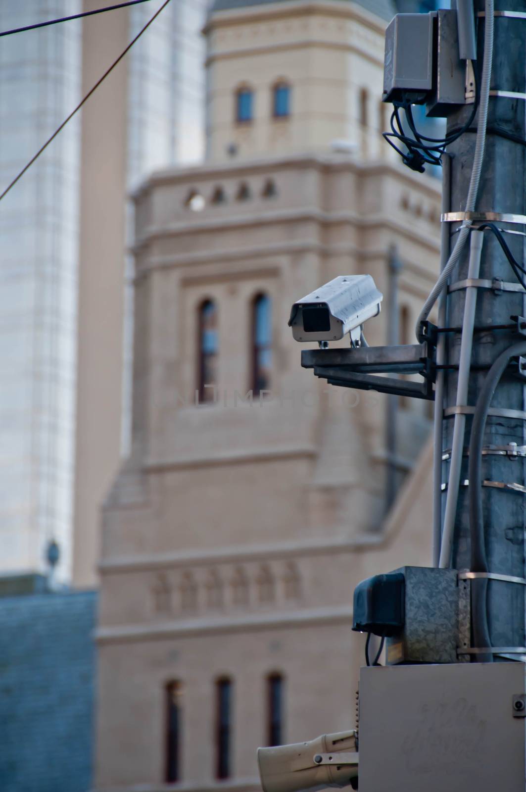 Surveillance CCTV street outdoor camera watching pedestrian near European cathedral church in city center to prevent terrorism