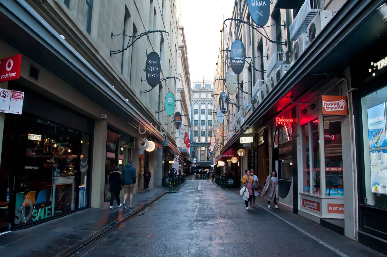MELBOURNE, AUSTRALIA - JULY 29, 2018: Degrave laneway in Melbourne city center in the morning with tourists stand and walk along the street. The laneway is a famous landmark of Melbourne city.