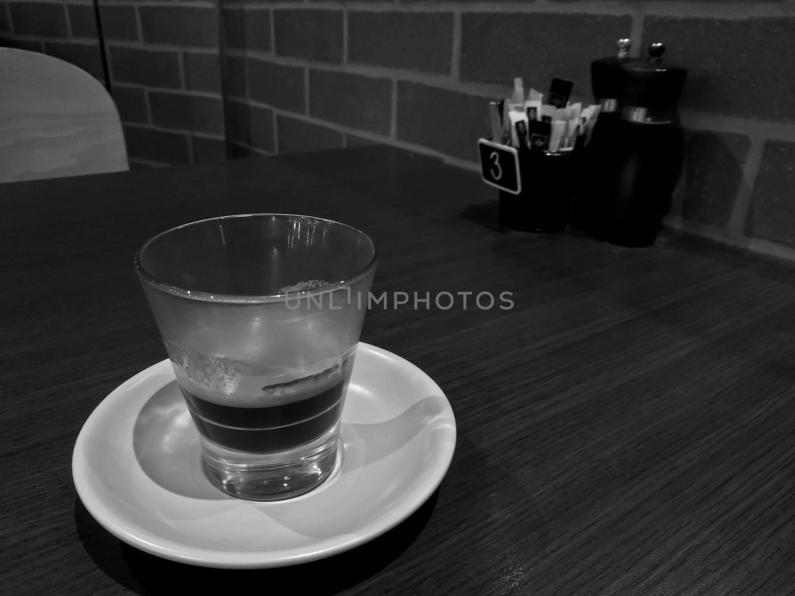 Concentrated freshly brewed hot Italian Espresso black coffee in black and white tone