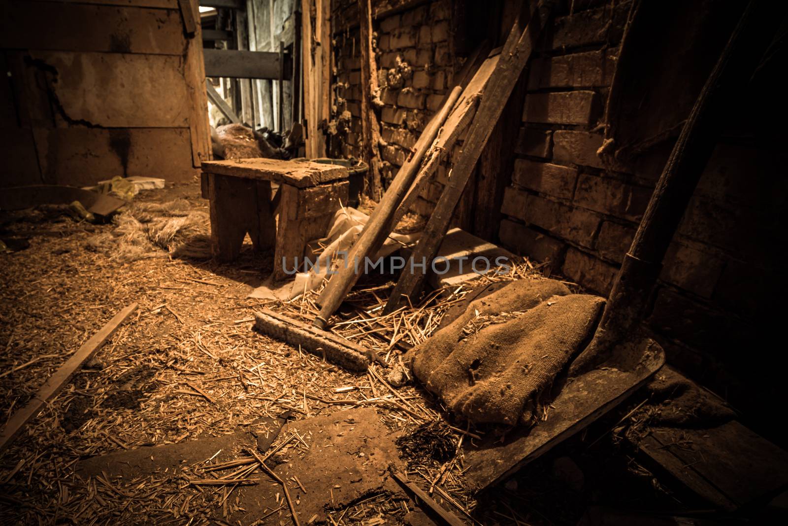 An old abandoned farm house, a lost place with dirty furniture and dusty paintings by mindscapephotos