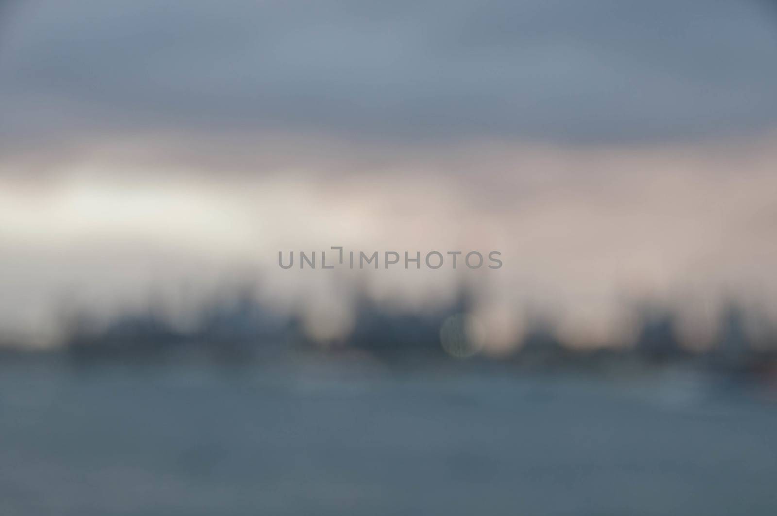 Blurred abstracted evening scene of skyscrapers horizon with ocean and tall office and residential towers in Melbourne Australia