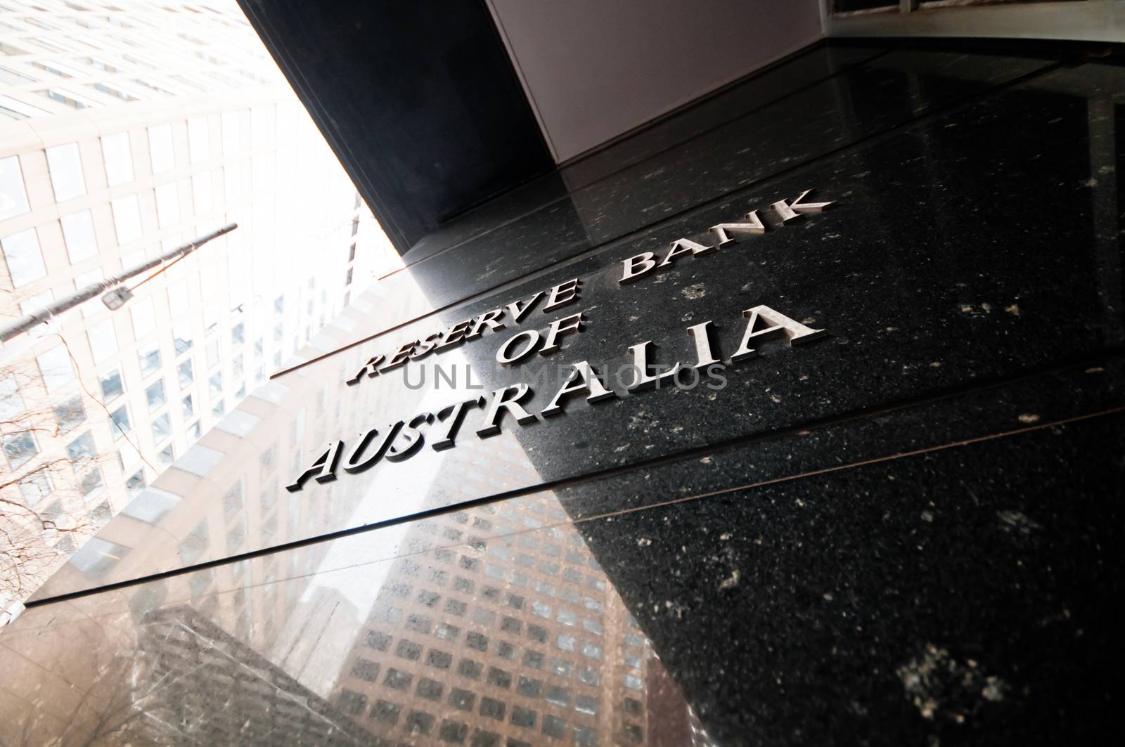 MELBOURNE, AUSTRALIA - JULY 26, 2018: Reserve Bank of Australia name on black granite wall in Melbourne Australia with a reflection of high-rise buildings. The RBA building is located at 60 Collins St, Melbourne VIC 3000 Australia.