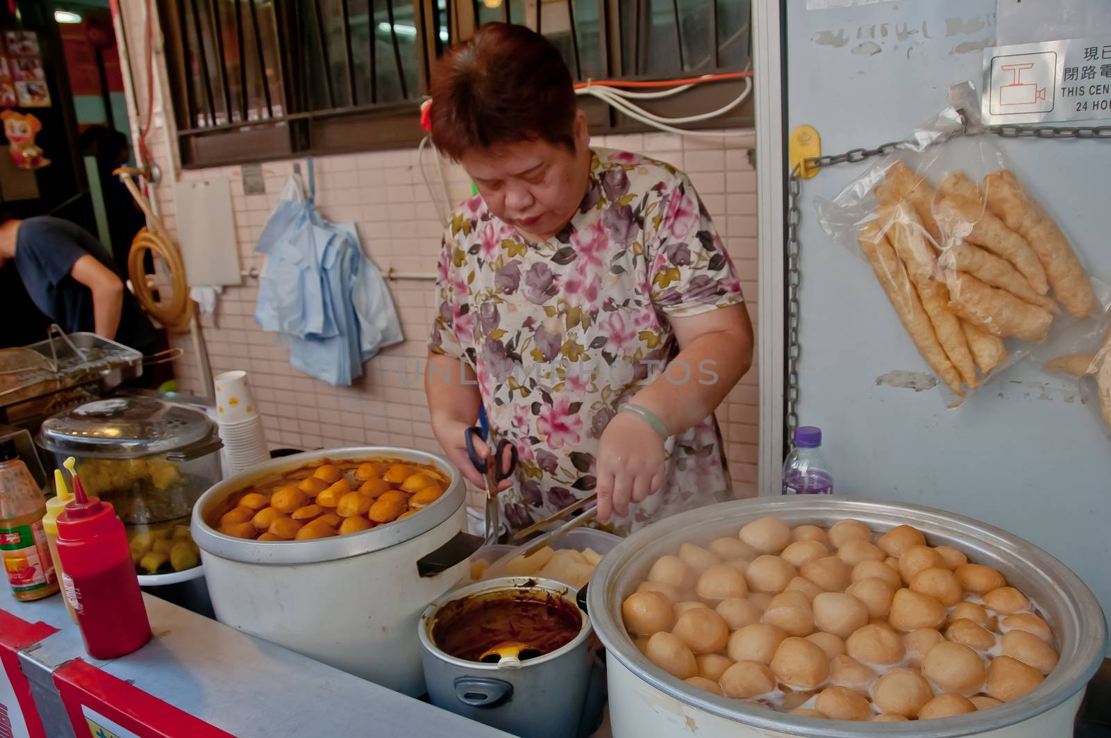 HONG KONG, HONG KONG SAR - NOVEMBER 18, 2018: Hong Kong spicy marinated XO sauce fish balls boil in large soup pot serving hot at street food stall by a local villager