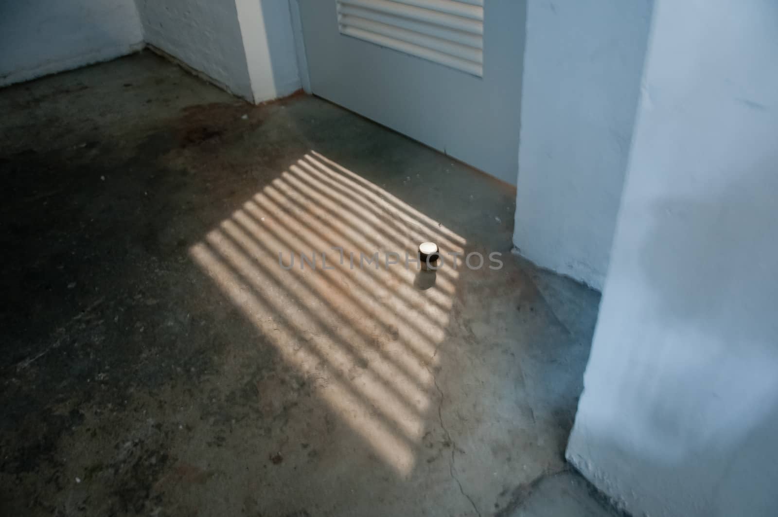 Abstract afternoon sun light shine through toilet door in vintage old building