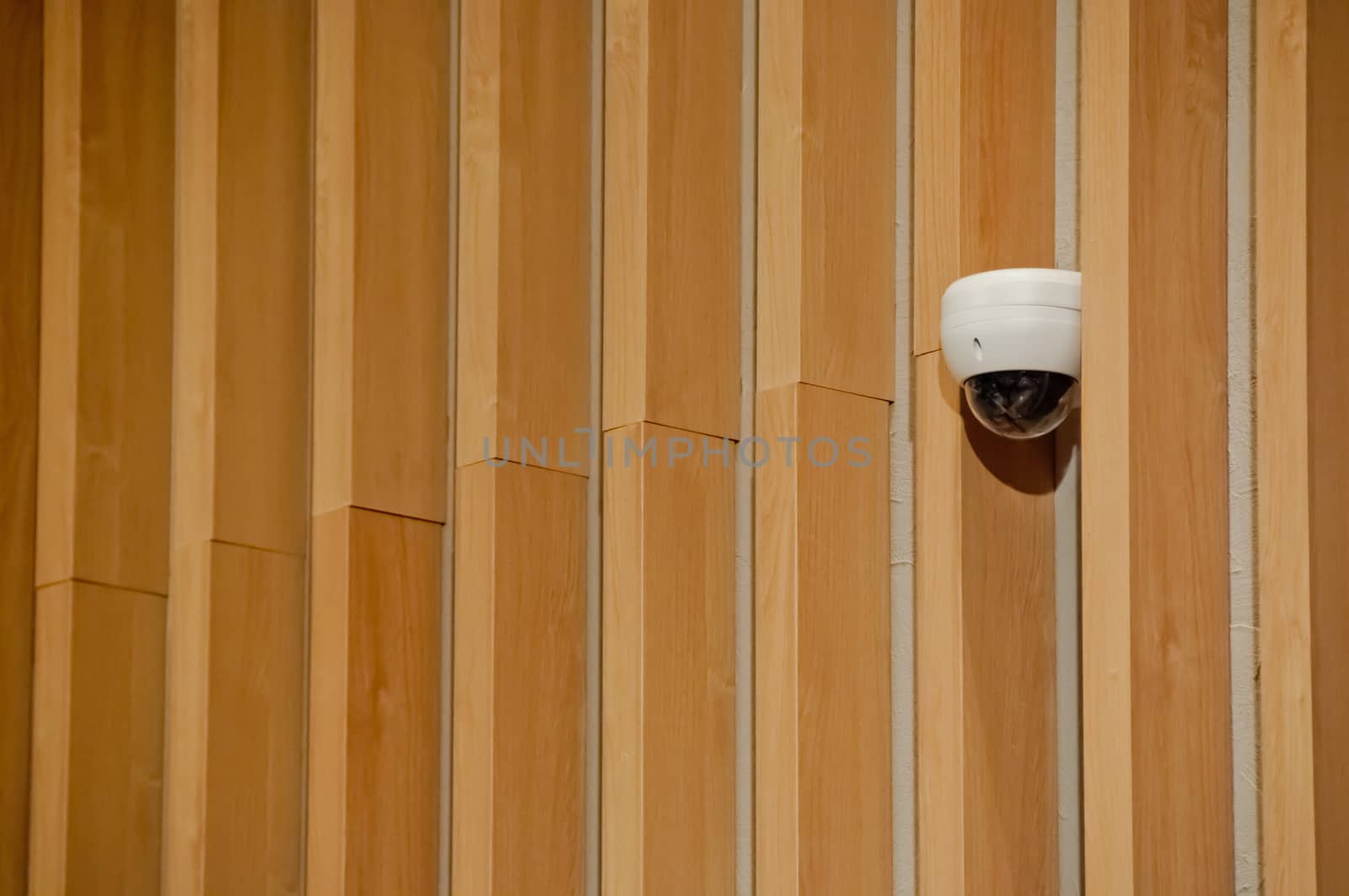 Modern white CCTV security camera dome  attached to wooden wall  by eyeofpaul