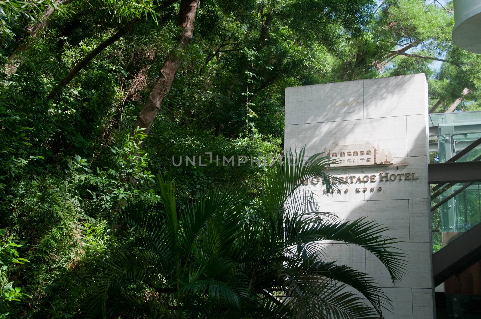 HONG KONG, HONG KONG SAR - NOVEMBER 18, 2018: Charming old classical vintage Tai O Heritage hotel situates in Tai O village in Hong Kong. The entrance of the hotel has big white stone name with lush green forest. Nobody is in the photo.