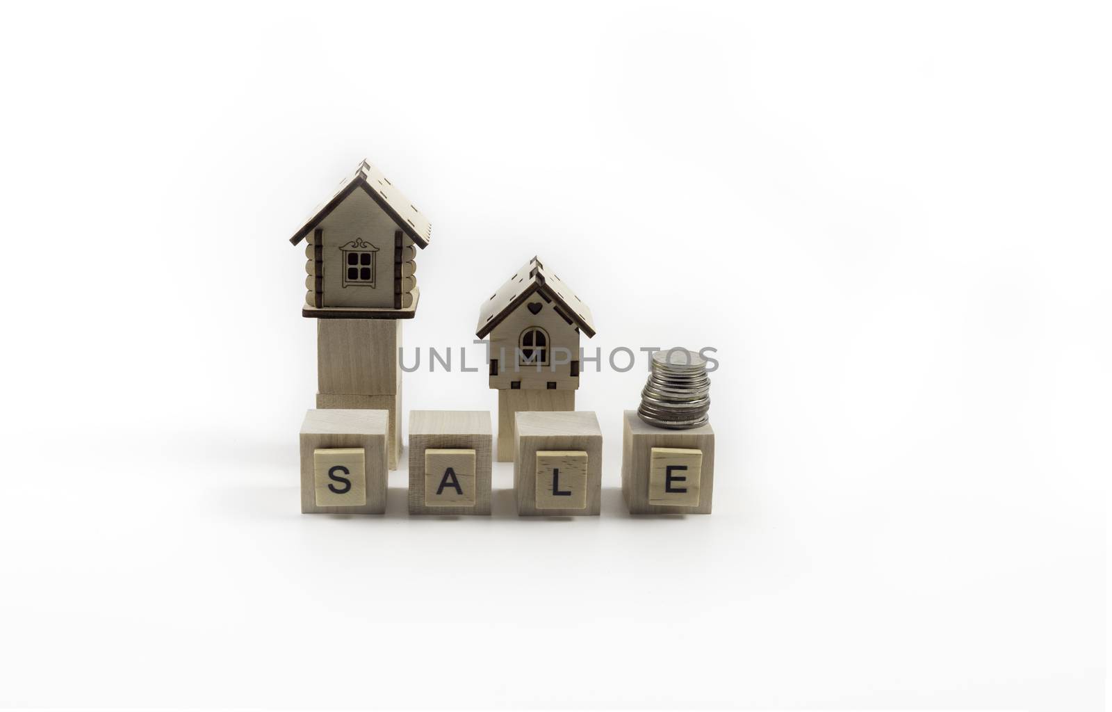 .Real Estate Sale Small Toy Wooden Houses and Sale Lettering.