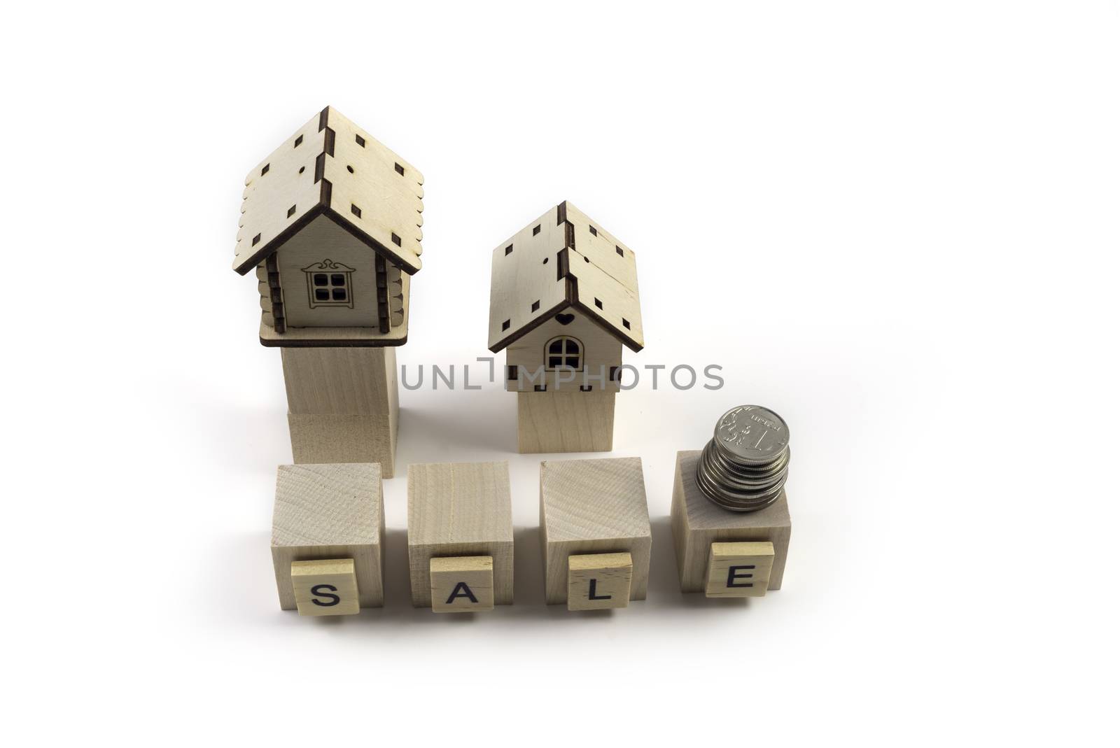 .Real Estate Sale Small Toy Wooden Houses and Sale Lettering by galinasharapova