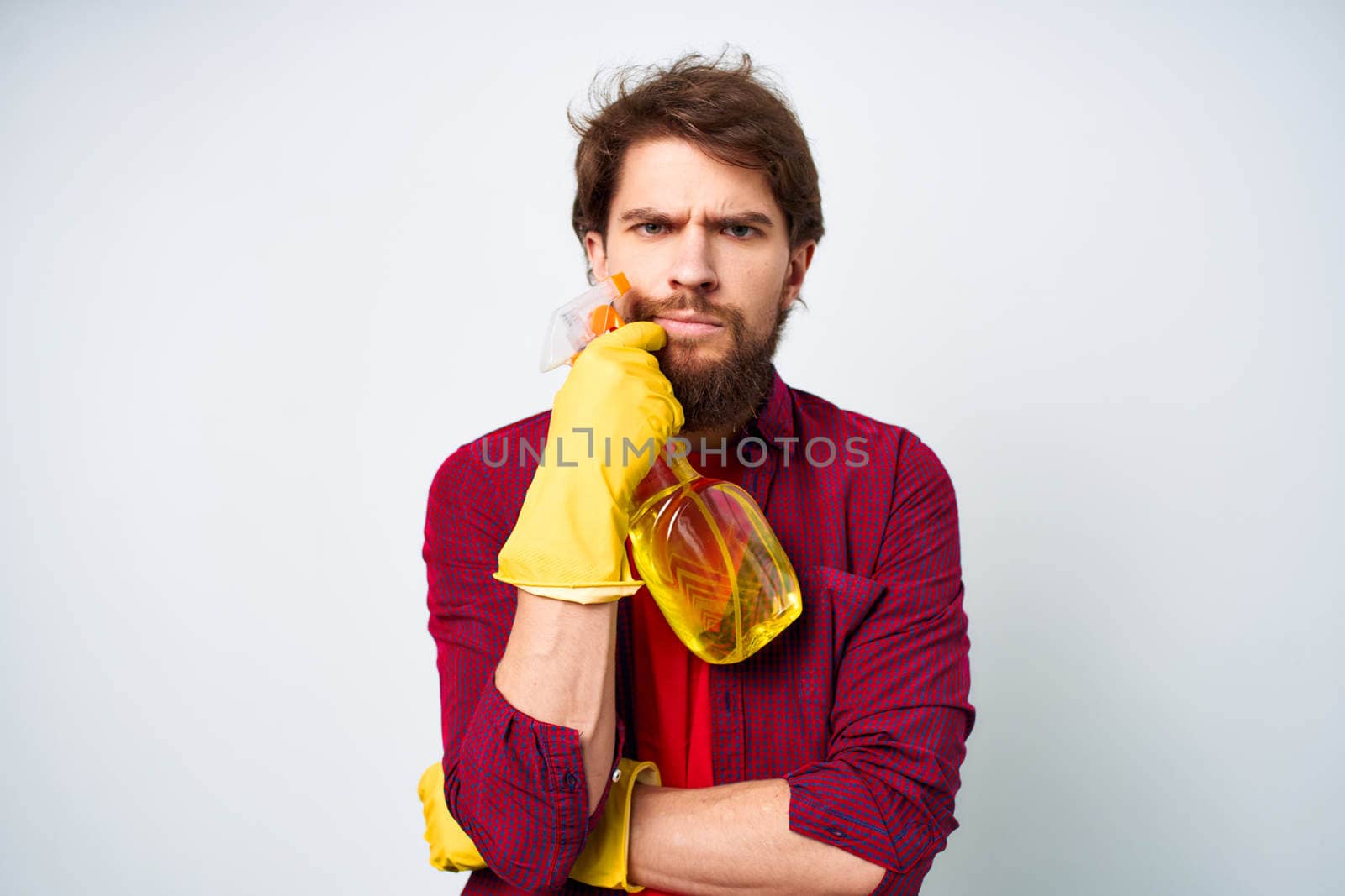 emotional man wearing rubber gloves detergent homework lifestyle professional. High quality photo