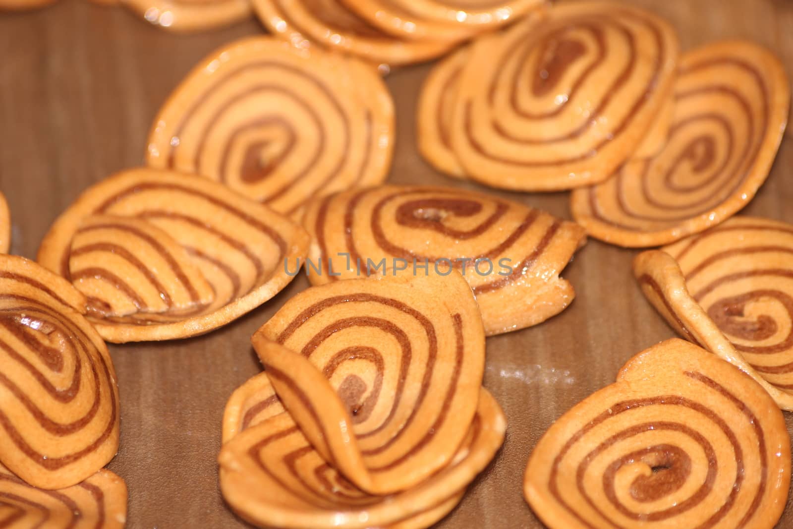 Closeup view with selective focus of a large number of round cookies with coconut filling lines.