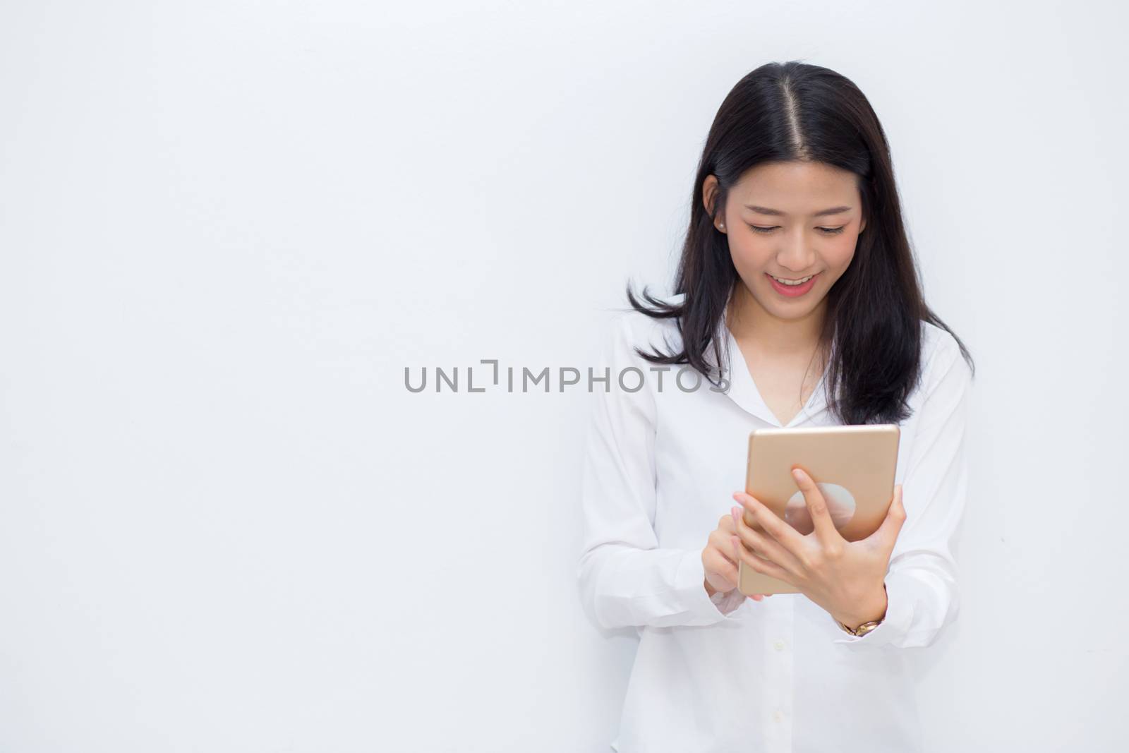 Beautiful portrait young asian woman using tablet computer cemen by nnudoo