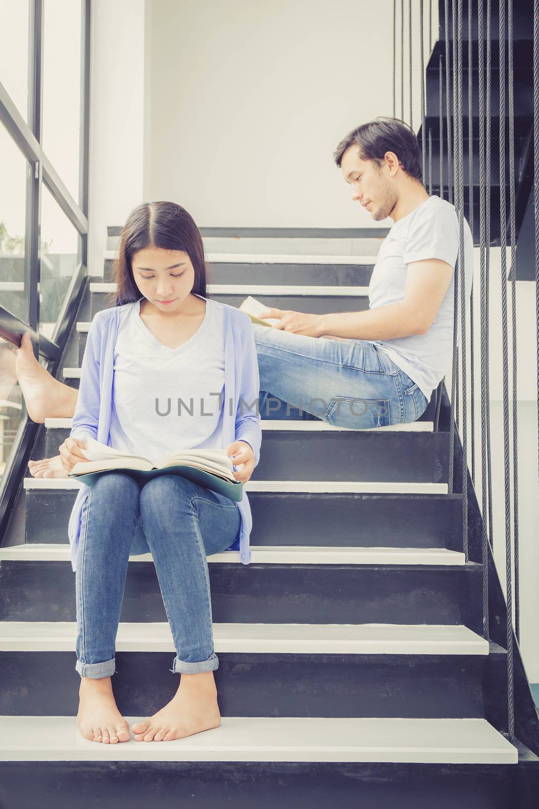 Couple asian handsome man and beautiful woman reading book and s by nnudoo