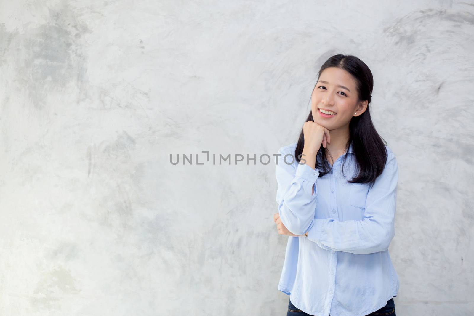 Portrait of beautiful young asian woman happiness standing on gr by nnudoo