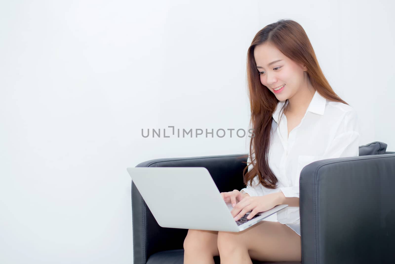 Beautiful young asian woman using laptop for leisure on sofa, girl working online with notebook freelance, communication business concept.