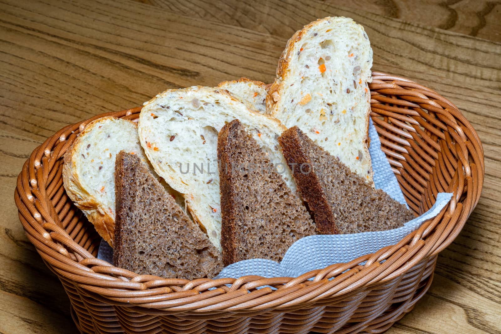 Black and white bread in a basket. Sliced ??bread in a basket. Pieces of bread are ready to eat