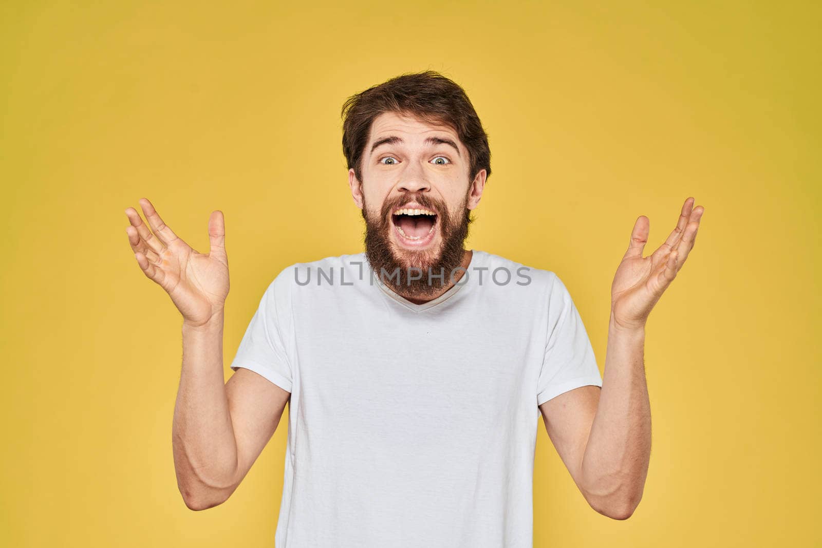 Bearded man on emotions white t-shirt fun lifestyle yellow background by SHOTPRIME